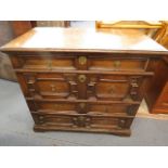 An early 18th century Jacobean style oak chest of four long drawers having panelled drawer front,