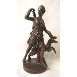 A 19th century bronze figure of a Grecian lady hold arrows, with stag by her side, on a circular