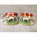 A pair of Victorian Staffordshire figurines of a cow and its calf