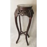 A Chinese carved and pierced rosewood, marble topped vase stand over cabriole legs