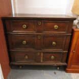 An 18th century provincial oak Jacobean style chest of three long drawers with panel prints on later