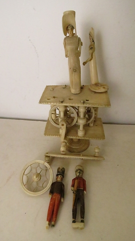 A Napoleonic prisoner of war bone automaton ornament, two tier construction with spinning wheel