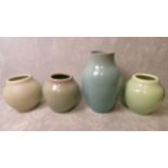 A group of four Pilkington Royal Lancastrian pottery vases, each in different glaze colours