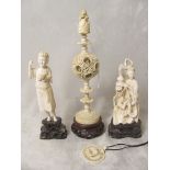 A 19th century Chinese carved ivory puzzle ball with finial in the form of an oriental man and a