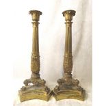 A pair of fine early to mid 19th century gilt brass candlesticks having ornate cast columns on