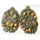 A pair of 19th century French carved wall plaques in the form of fruit and leaves, highlighted in