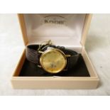 A Kolber Quartz movement wrist watch in a 14k gold plated case and leather strap, in original box