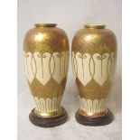 A pair of Japanese Satsuma vases decorated with flower heads and gilt work, gilt on black seal marks