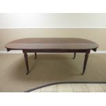 A 19th Century mahogany Extending Dining Table with one spare leaf on ring turned tapering legs with