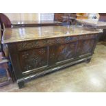 A Charles II oak Coffer with moulded top and lozenge carved three panel front, 4ft 11in W