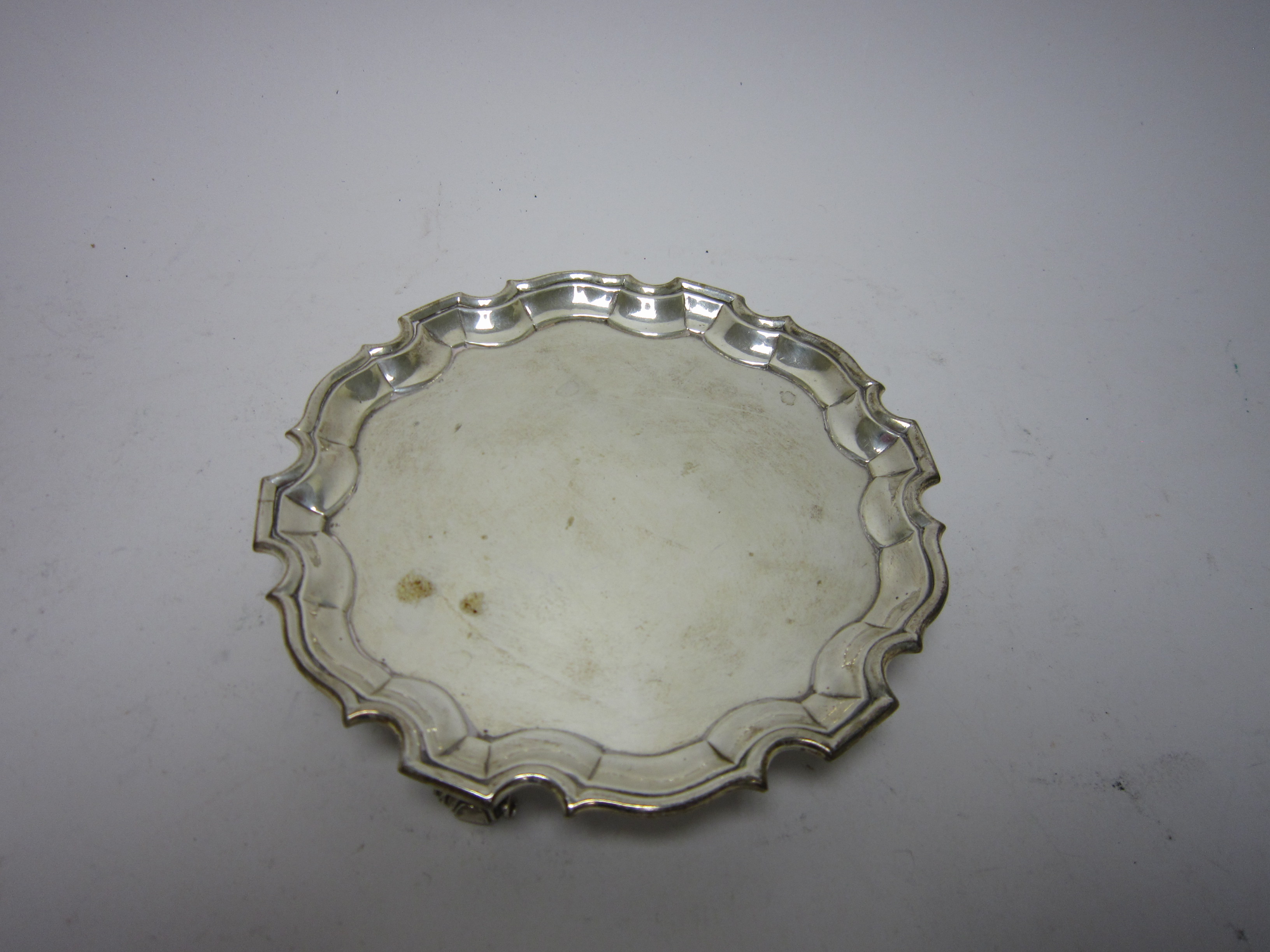 A George II silver shaped circular Salver on three scroll feet, London 1738, maker: G.H., 6in diam