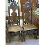 Pair of 18th Century oak high back Side Chairs with scroll carved cresting rails, shaped splat backs