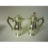 Pair of George V silver baluster Hot Water Jugs with scroll handles, London 1937/8