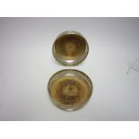 Pair of pierced silver circular Coasters with engraved leafage friezes and turned wooden bases,