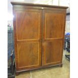 A George III inlaid mahogany Channel Island Wardrobe, the moulded cornice above a pair of panelled