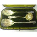 Pair of Victorian silver shell bowl Serving Spoons and Sugar Sifter with scroll handles, London