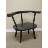 A primitive oak Armchair with shaped back and seat on four chamfered supports