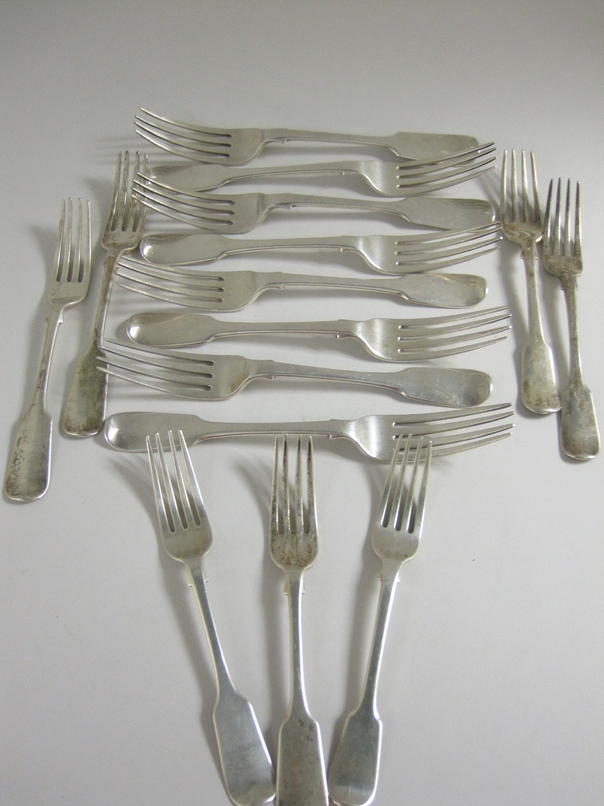 Eight early 19th Century silver Dinner Forks fiddle pattern engraved initials and crest, London