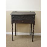 A 17th Century oak Bible Box on later stand with fitted interior, carved frieze above a drawer,