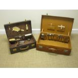 Two leather Travelling Cases, both with part sets of silver mounted fittings