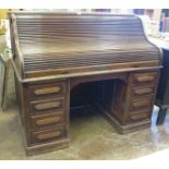 An American fielded panel oak Roll Top Desk, the tambour shutter revealing a fully fitted interior