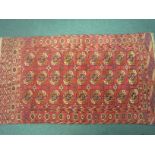 A bordered Tekke Turcoman Rug with three rows of conjoined guls on a red ground, 5ft 6in x 3ft and a