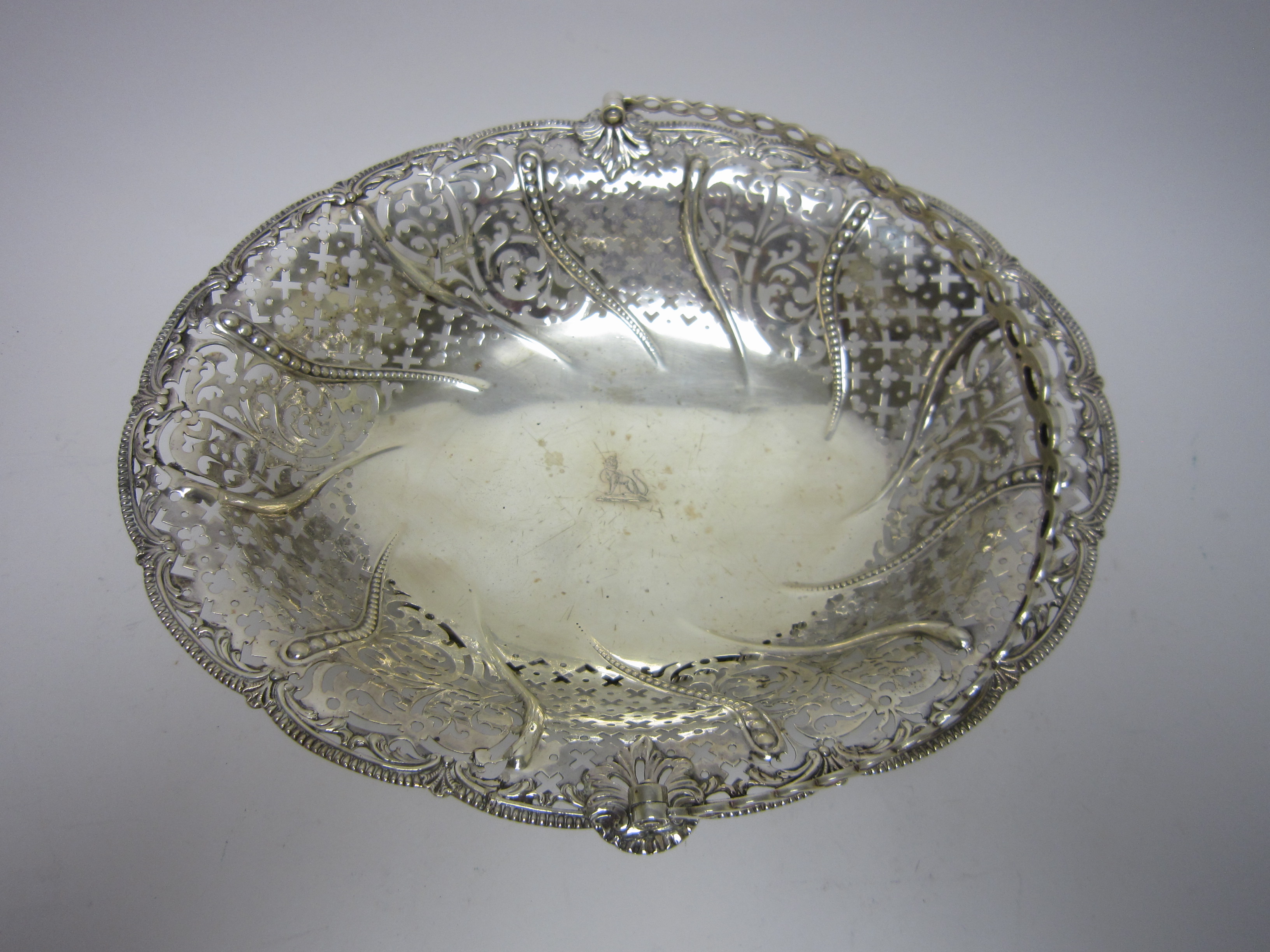 A George III silver pierced oval Cake Basket engraved crest, later swing handle, London 1760,