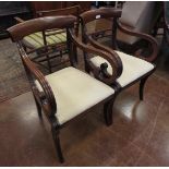 A pair of Regency mahogany Armchairs, the bar backs and swept arms above drop in seats, raised on