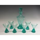 An Art Deco faceted green glass Cocktail Set comprising Decanter, Stopper and six Glasses, chip to