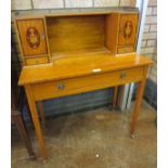 A Sheraton style Bonheur De Jour with pierced brass gallery above two small cupboards with oval