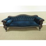 A Victorian mahogany framed Sofa with carved ribbon detail to back rail mounted on heavily carved