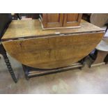 An antique oak double gate-leg Table with rounded ends on turned and square supports and square