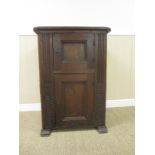 An 18th Century Continental oak Cupboard with moulded top and two panelled doors, 3ft 2in H x 2ft