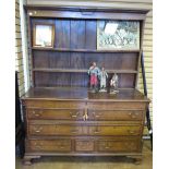 An 18th Century oak Lancashire Dresser with later Rack having hinged top above two dummy drawers and