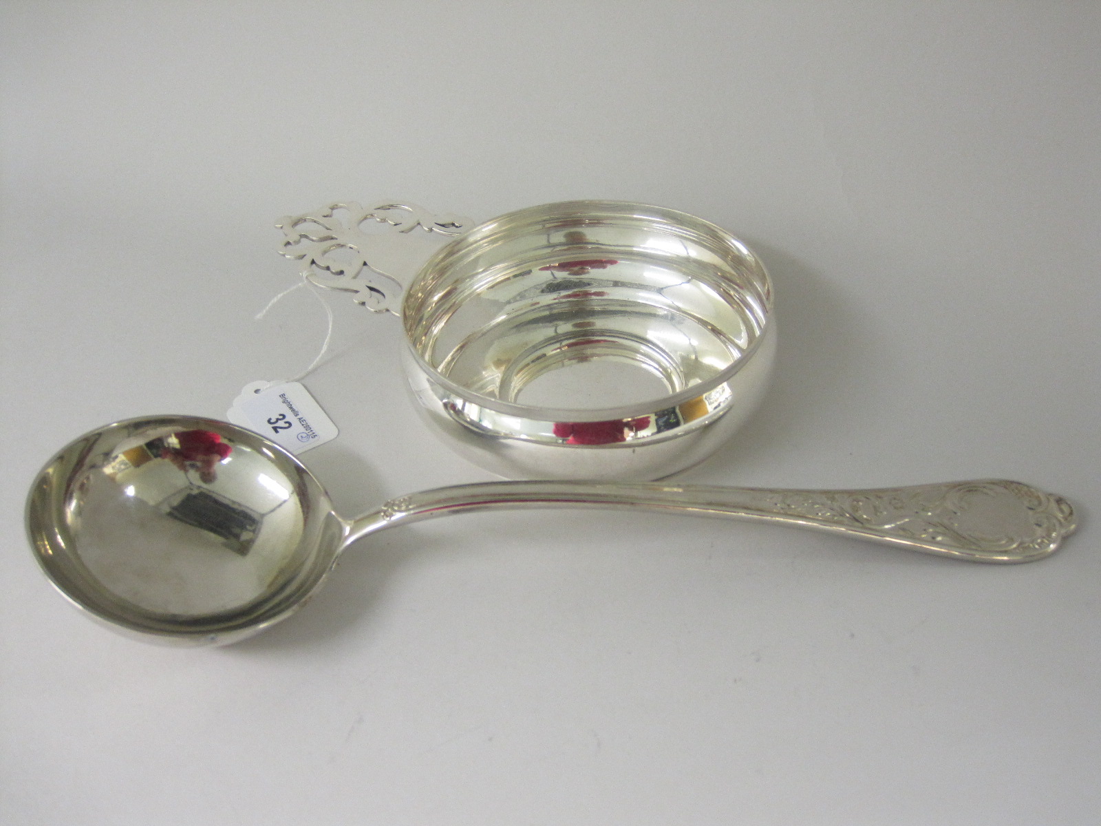 A Tiffany & Co silver heavy Porringer with single pierced flat section handle and a Continental