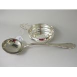 A Tiffany & Co silver heavy Porringer with single pierced flat section handle and a Continental