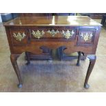 An antique oak Lowboy fitted three drawers on cabriole supports and pad feet, 34in W x 18in D
