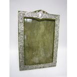 A large Photograph Frame with bird and floral scroll embossed silver mount having vacant