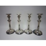 A set of four plated Pillar Candlesticks on lobed circular bases