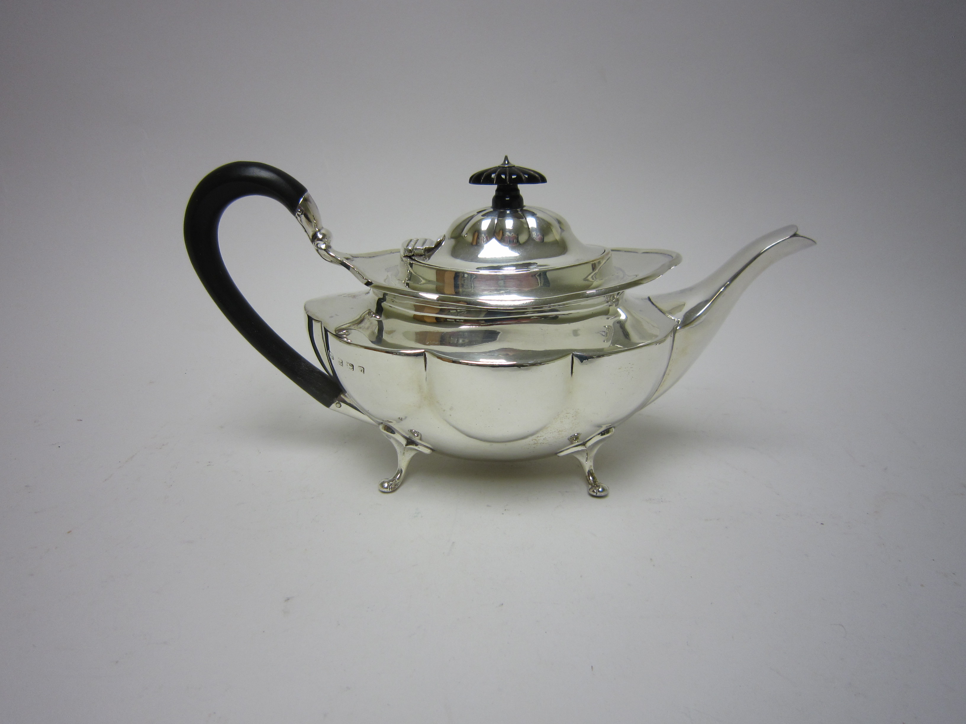 An Edward VII silver Teapot of shaped oval form with ebonised scroll handle, Birmingham 1907