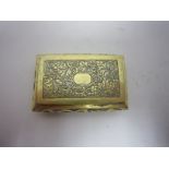 An Oriental white metal and gilt Vinaigrette with fruiting vine engraved lid having vacant