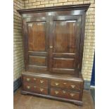 An 18th Century oak Hall Cupboard with pair of cross-banded and fielded panelled doors enclosing