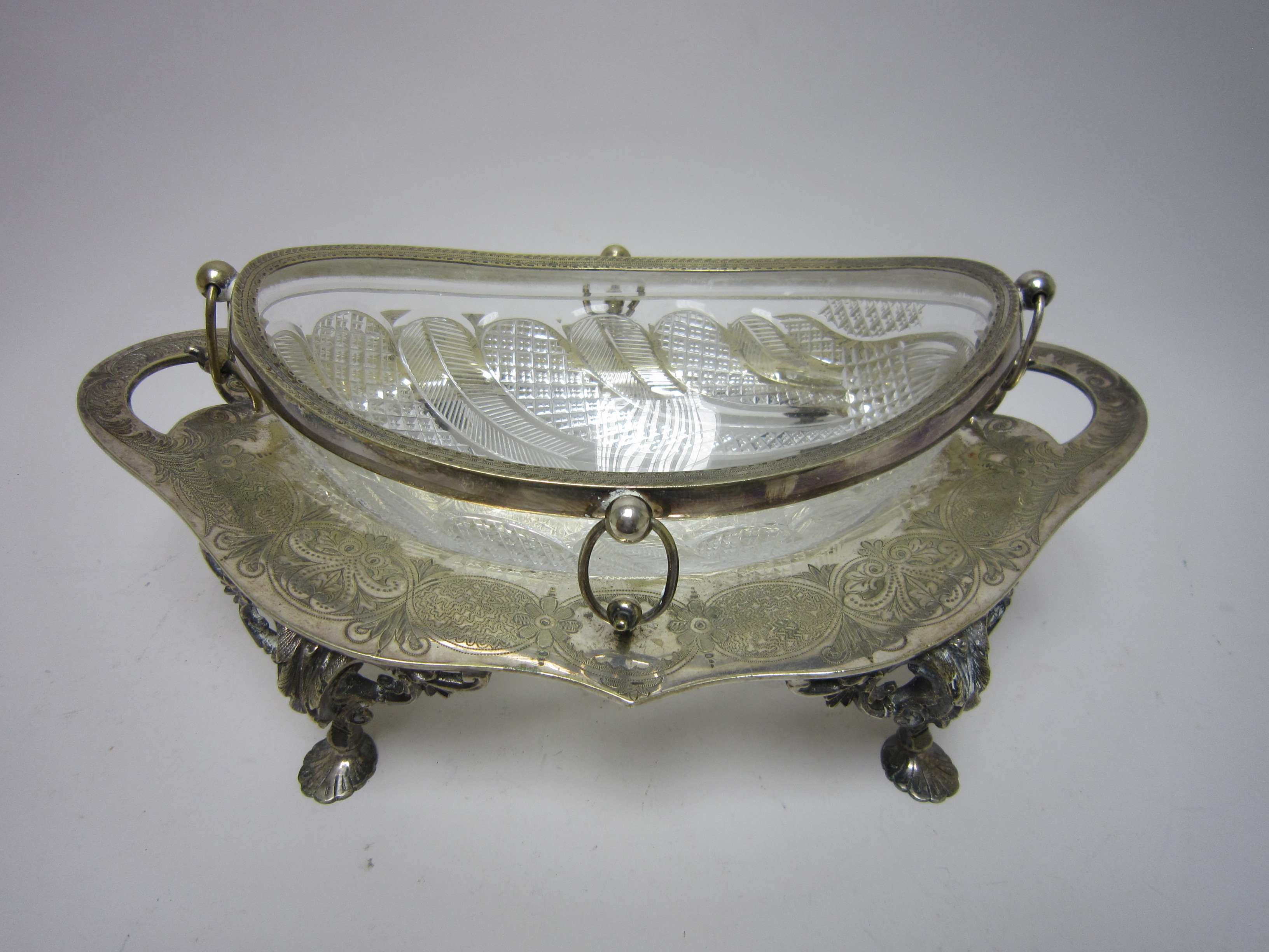 An EP mounted cut glass oval Fruit Bowl on stand with floral engraved frieze, leafage scroll