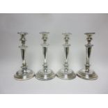 A Set of four 19th Century Sheffield plated Pillar Candlesticks with tapering columns, gadroon