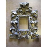 A carved wood picture frame in the baroque style, inset size 4 3/4 x 3 3/4 in