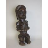 A carved African Figure of a seated female, 26in H