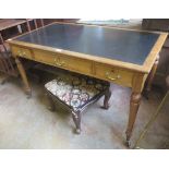 A Victorian oak Writing Desk with leather inset top, fitted three frieze drawers on turned