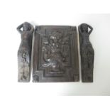 An antique oak floral carved Panel and two small carved oak Figures
