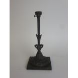 A 19th Century cast iron Stand with embossed foliate decoration and reeded column on square base,