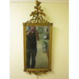 A Regency style gilt framed Wall Mirror with rose and ribbon surmount and rose decorated corners,